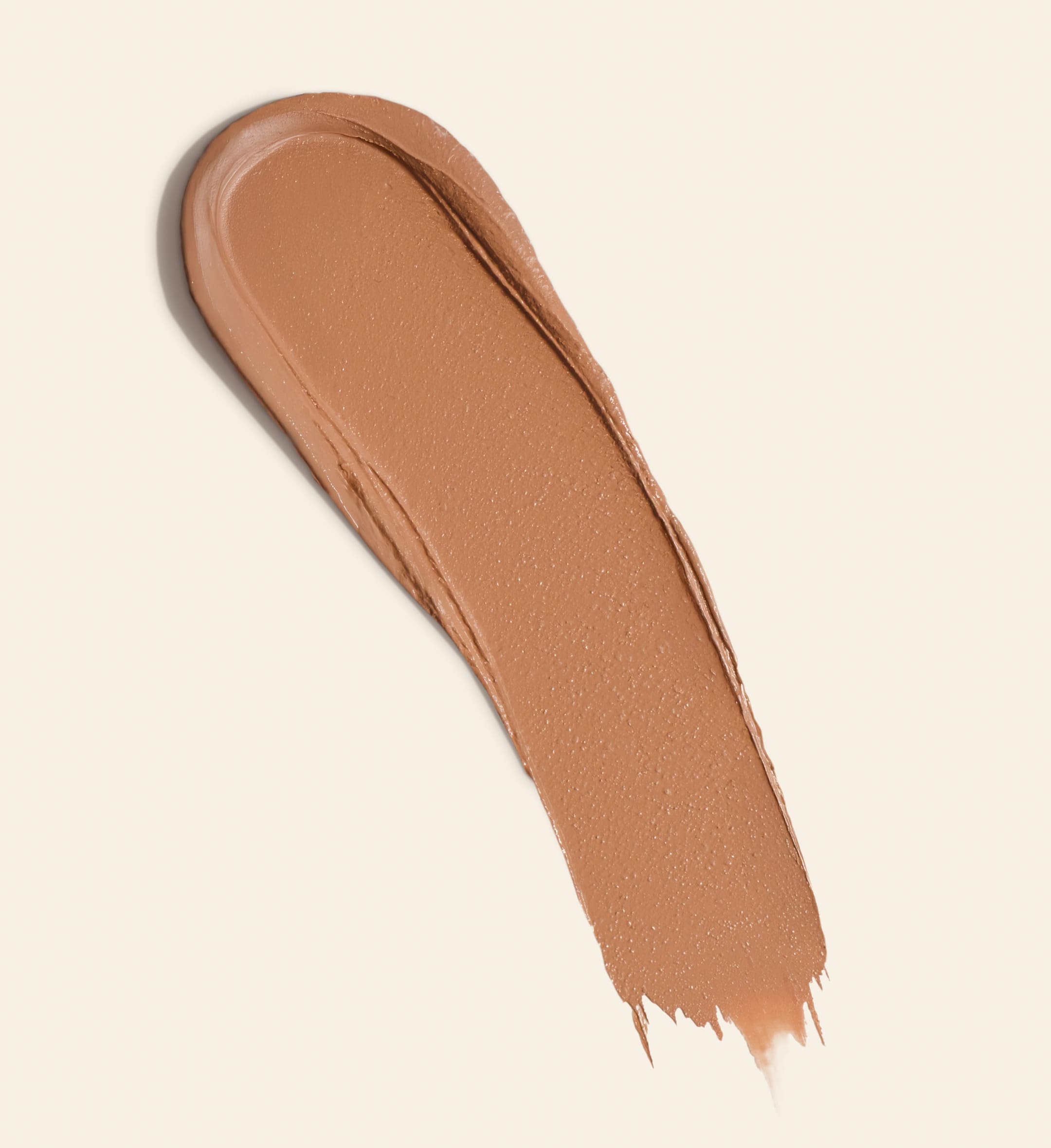 Soft Tan Bronzer romige swatch in de kleur Light toont de opbouwbare formule voor een natuurlijke gloed.